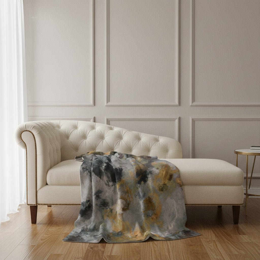 Terra Firma plush blanket draped over a cream tufted sofa